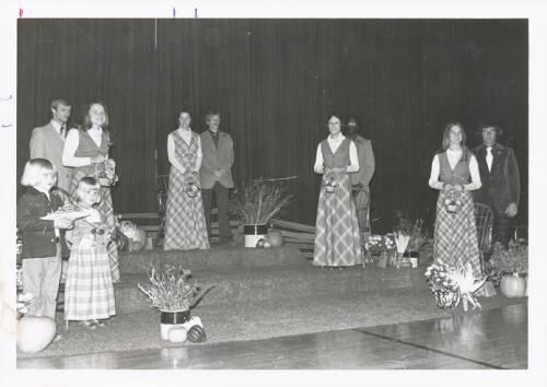 The 1976 Homecoming court on the coronation ceremony stage. L to R: junior Nancy Yeager, Queen Jane Roeschley, senior Anna Simcox and sophomore Joyce Baumgartner , with their escorts.