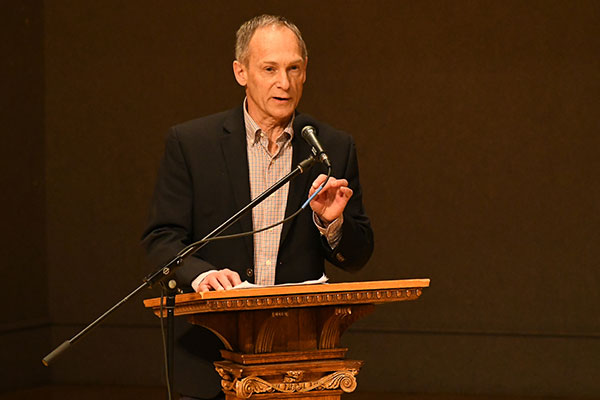 Dr. Duane Stoltzfus, professor of communication at Goshen College, told stories of three conscientious objectors seeking US citizenship. 