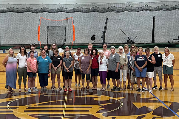 Former female student athletes gathered in 2022 for a reunion with Coach Kim Fischer.