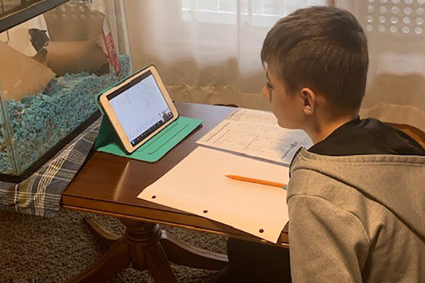 Keane Arron gets help with homework from his Bluffton Study Buddy.