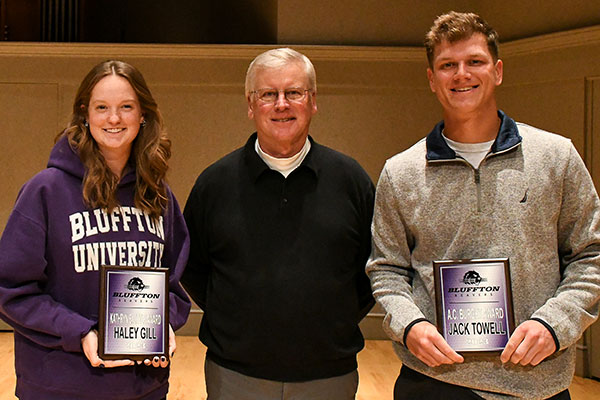 Coach Burrow poses with outstanding senior athletes of the year, Haley Gill and Jack Towell.