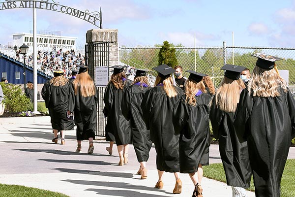 2021 graduates process into Salzman Stadium