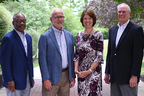 Retiring trustee Lawrence E. Milan ’73, retiring vice president for advancement Dr. Hans Houshower, President Dr. Jane Woods and retiring trustee James T. Sommer ’68. 