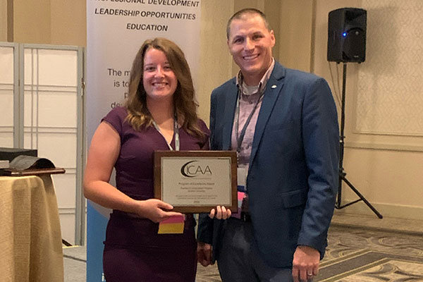 Claire Clay, director of public relations and enrollment operations accepted the Program of Excellence Award from Kyle Vaughn, executive director of institutional advancement at Ashland University & ICAA Summer Conference co-chair.