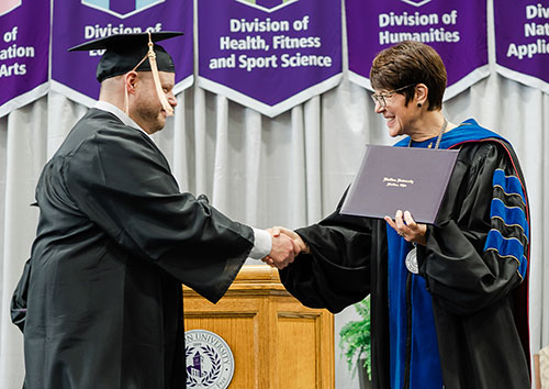 President Wood presents diploma